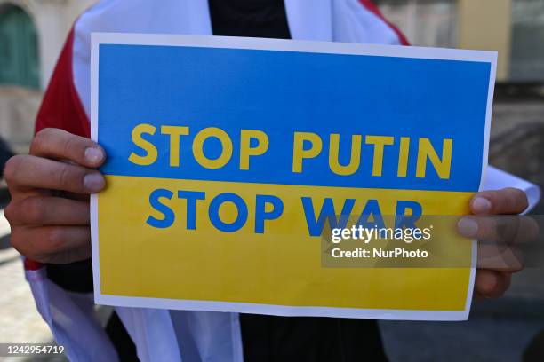 Protester holds a poster with words 'Stop Putin, Stop War'. Members of the local Belarusian and Ukrainian diaspora supported by local activists are...