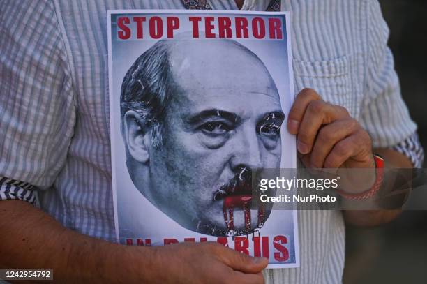 Protester holds a poster with an image of President of Belarus, Alexander Lukashenko, and inscription 'Stop Terror In Belarus'. Members of the local...