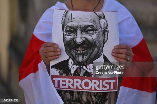 Protester holds a poster with an image of President of Belarus, Alexander Lukashenko, and inscription 'Terrorist'. Members of the local Belarusian...