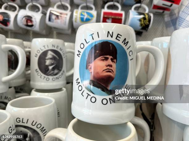 Picture taken on August 26, 2022 shows a mug with the image of late Italian politician, military and founder of the Fascism Benito Mussolini and an...