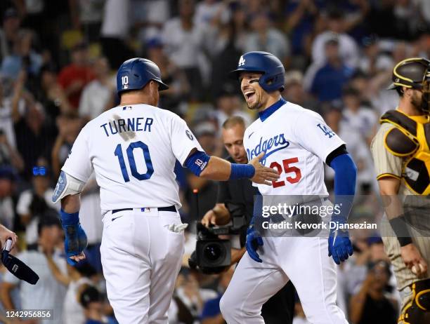 Trayce Thompson of the Los Angeles Dodgers is congratulated at home plate by Justin Turner after hitting a three-run home run against relief pitcher...