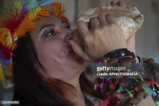 An Indigenous woman plays a conch during a ceremony on International Indigenous Women's Day on September 4, 2022 in Sonsonate, El Salvador....