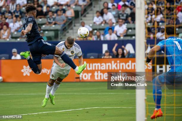 Dejan Jovelji of Los Angeles Galaxy heads the ball toward goal as Kayden Pierre of Sporting Kansas City defends during the match at the Dignity...