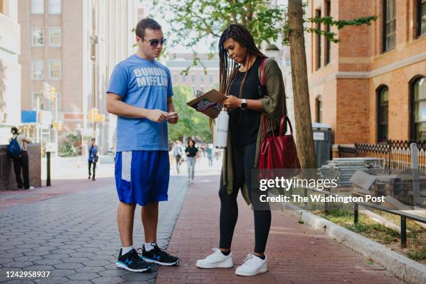 Coby Rich a junior at the University of Pennsylvania, helps Chelsea Perry an MBA student at the Wharton School of Business, register to vote in...