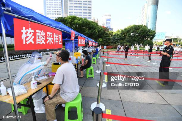 Medical staff conduct nucleic acid samples for people at the nucleic acid sampling point of Zhucheng Square in Guiyang, Guizhou province, China, Sept...