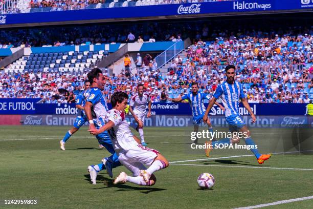 Alberto Escassi , Riki Rodriguez and Juande Rivas seen in action during the LaLiga Smartbank 2022/2023 match between Malaga CF and Albacete Balompie...