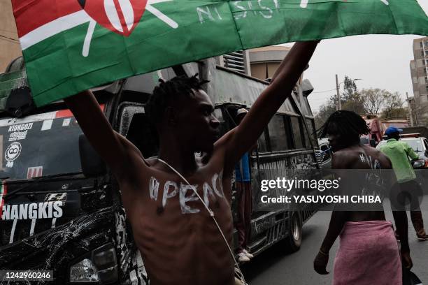 Supporters of Kenya's defeated presidential candidate for the Azimio La Umoja Party coalition, Raila Odinga, gather near a Police check point on a...