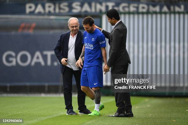 S manager Luis Campos and president Nasser Al-Khelaifi greet Paris Saint-Germain's Argentinian forward Lionel Messi as he arrives for a training...