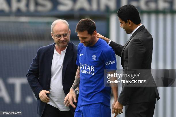 S manager Luis Campos and president Nasser Al-Khelaifi greet Paris Saint-Germain's Argentinian forward Lionel Messi as he arrives for a training...