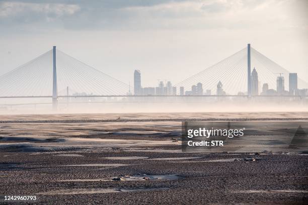 This photo taken on September 2, 2022 shows a section of a parched river bed along the Yangtze River in Wuhan in China's central Hubei province. -...