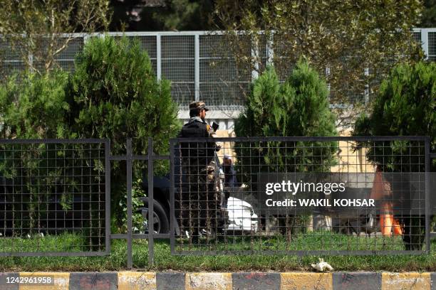Taliban fighter stands guard in front of the Russian embassy after a suicide attack in Kabul on September 5, 2022. - A suicide bomber struck near the...