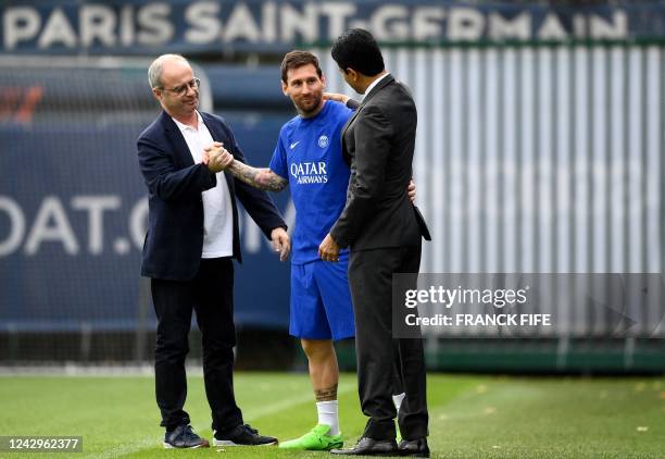 Paris Saint-Germain's manager Luis Campos and President Nasser Al-Khelaïfi greet Paris Saint-Germain's Argentinian forward Lionel Messi as he arrives...