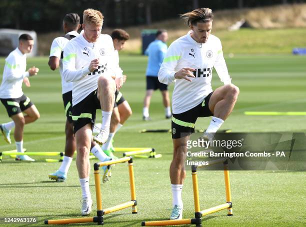 Manchester City's Jack Grealish and Manchester City's Kevin De Bruyne during a training session at the City Football Academy, Manchester. Picture...