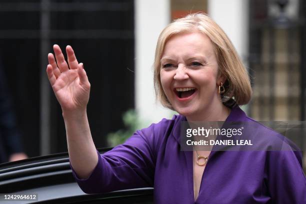 New Conservative Party leader and incoming prime minister Liz Truss smiles and waves as she arrives at Conservative Party Headquarters in central...