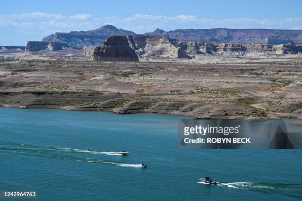 People enjoy the water of the Colorado River in Lake Powell, despite lower than normal water levels, in Wahweap Bay in Page, Arizona, on September 3,...