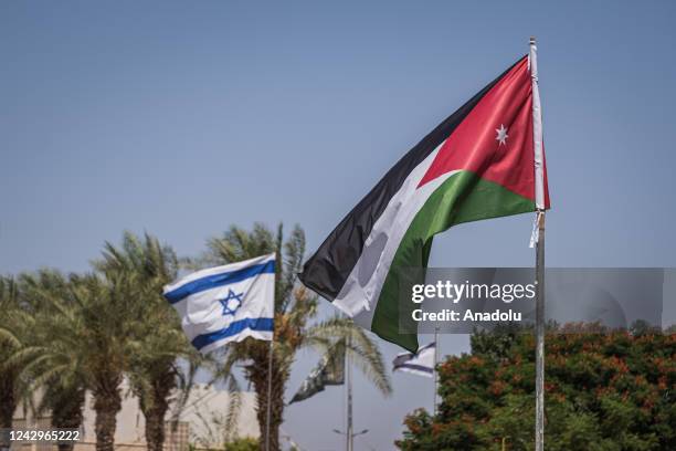 Jordanian and Israeli flag at the Baptism Site in Amman, Jordan on August 26, 2022. Water levels of Jordan River decreases due to climate change and...