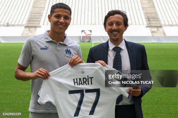 Marseille's Moroccan midfielder Amine Harit poses with Marseille's Spanish president Pablo Longoria with Olympique de Marseille's jersey after his...