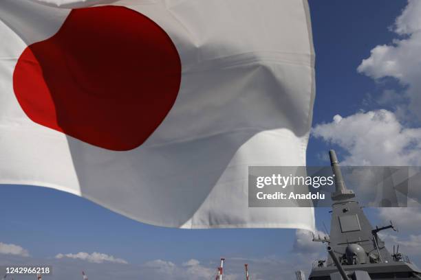 Japan's naval ship âMogamiâ, featuring stealth capability, is seen next to Japanâs national flag at the Japan Maritime Self-Defense Force naval base...