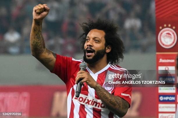 Olympiakos' new Brazilian player Marcelo waves to the fans during his official presentation at the Georgios Karaiskakis stadium in Athens on...