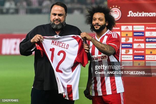 Olympiakos' new Brazilian player Marcelo holds his jersey with Olympiakos' owner Evangelos Marinakis during an official presentation at the Georgios...