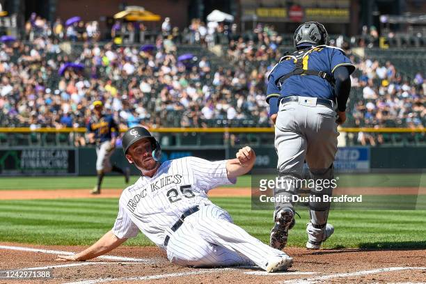 Cron of the Colorado Rockies scores in the first inning against the Milwaukee Brewers at Coors Field on September 5, 2022 in Denver, Colorado.