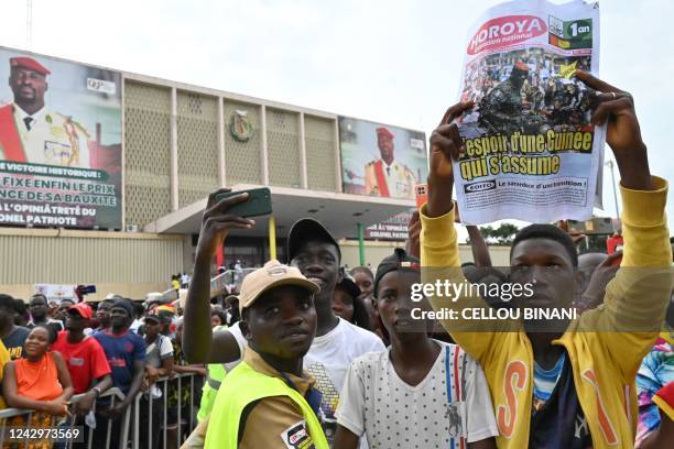 Supporter holds up a newspaper at a concert to commemorate the one year anniversary of The National Committee of Reconciliation and Development , the...