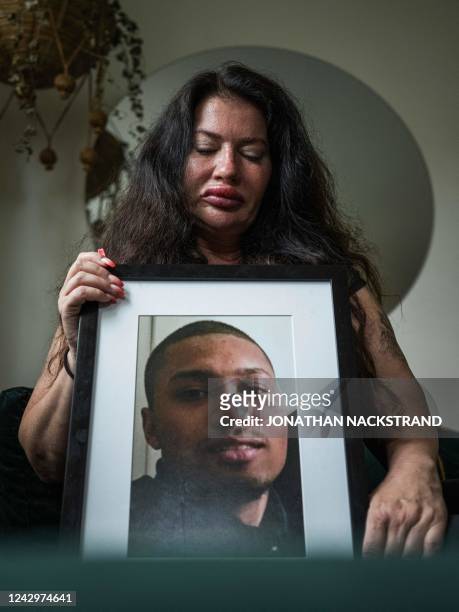 Maritha Ogilvie, mother of Marley, shot dead in 2015, holds a picture of her son one June 24 in Stockholm, Sweden. - Gang shootings have escalated...
