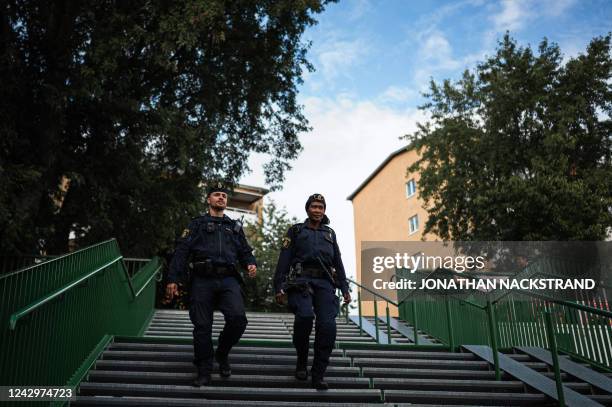 Police officers Michael Cojocaru and Rissa Seidou patrol the main square in Rinkeby, Sweden, on August 31, 2022. - Gang shootings have escalated and...