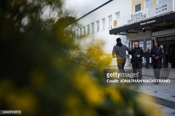 Police officers Michael Cojocaru and Rissa Seidou patrol the main square in Rinkeby, Sweden, on August 31, 2022. - Gang shootings have escalated and...