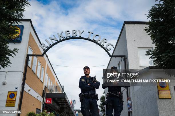 Police officers Michael Cojocaru and Rissa Seidou patrol the main square in Rinkeby, Sweden, on August 31, 2022. - Gang shootings have escalated and...