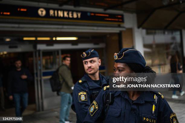 Police officers Michael Cojocaru and Rissa Seidou patrol the main square in Rinkeby, Sweden, on August 31, 2022. Gang shootings have escalated and...