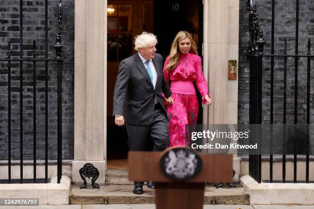 British Prime Minister Boris Johnson arrives with his wife Carrie Johnson as he prepares to deliver a farewell address before his official...