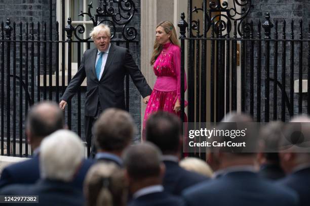 British Prime Minister Boris Johnson walks out of 10, Downing Street with his wife Carrie before delivering a farewell address to mark his official...