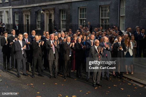 MPs and members of Boris Johnson's cabinet clap as British Prime Minister Boris Johnson leaves after delivering a farewell address on his official...