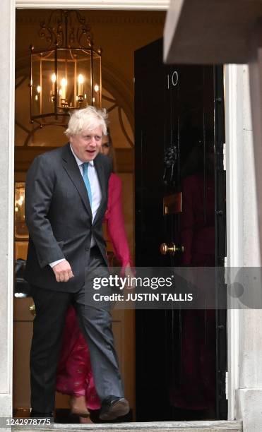 Britain's outgoing Prime Minister Boris Johnson and his wife Carrie Johnson come out as Johnson prepares to deliver his final speech outside 10...