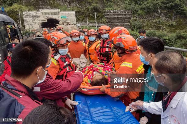 Rescue workers carry an injured person after a 6.6-magnitude earthquake in Luding county, Ganzi Prefecture in China's southwestern Sichuan province...