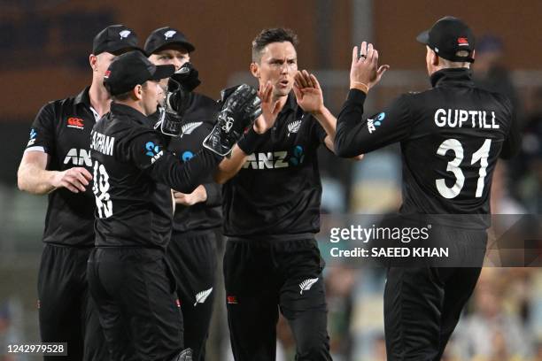 New Zealand's Trent Boult celebrates with teammates after taking the wicket of Australia's Aaron Finch during the first one-day international cricket...