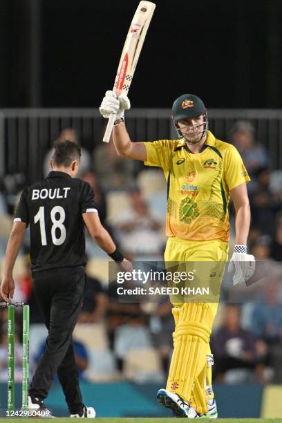 Australia's Cameron Green celebrates reaching his half century during the first one-day international cricket match between Australia and New Zealand...