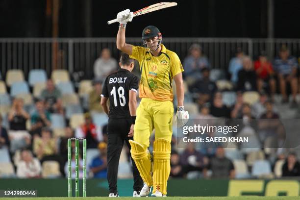 Australia's Cameron Green celebrates reaching his half century during the first one-day international cricket match between Australia and New Zealand...