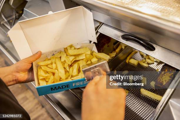 Chef scoops a portion of chips into a box in a fish and chips takeaway in London, UK, on Saturday, Sept. 3, 2022. The government has been criticized...