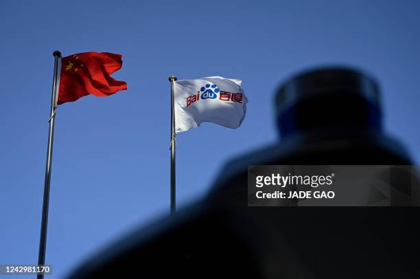 This picture shows a Baidu and Chinese national flag at Baidu's headquarters in Beijing on September 6, 2022.