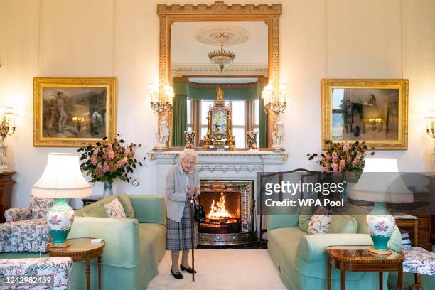 Queen Elizabeth II waits in the Drawing Room before receiving newly elected leader of the Conservative party Liz Truss at Balmoral Castle for an...