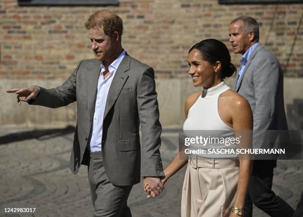 Meghan, Duchess of Sussex , and Prince Harry, Duke of Sussex leave the the city hall in Duesseldorf, western Germany, on September 6, 2022 after...