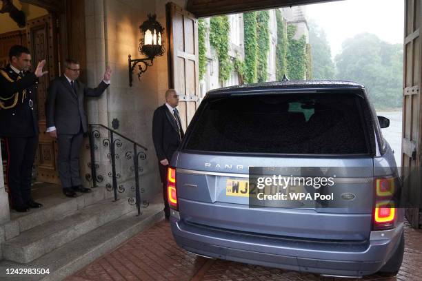 Queen Elizabeth II's Equerry Lieutenant Colonel Tom White and her Private Secretary Sir Edward Young wave goodbye to the new Prime Minister Liz Truss...