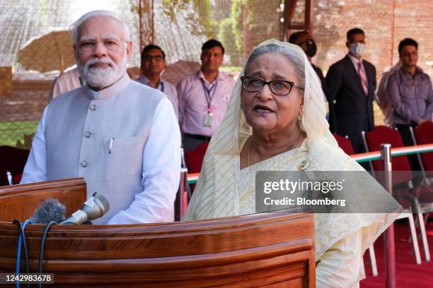 Sheikh Hasina, Bangladesh's prime minister, right, along with Narendra Modi, India's prime minister, speaks to the media during a ceremonial...