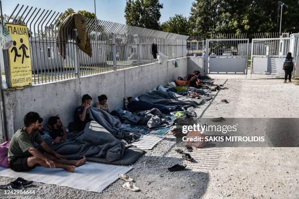 Yazidi migrants from Iraq wait for the entry into a refugee camp in Serres, northern Greece, on September 6, 2022 as they have been stranded outside...