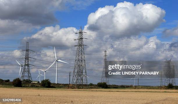 Electricity pylons holding power cables leading away from the SSE gas-fired Keadby Power Station, are pictured along with wind turbines near...