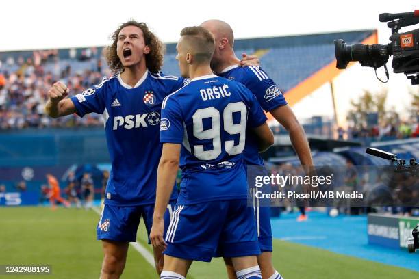 Mislav Orsic of Dinamo Zagreb celebrates with teammates after scoring his team's first goal during the UEFA Champions League group E match between...