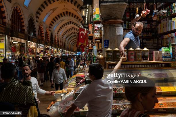 Salesman serves customers in The Spice Bazaar, Eminonu District in Istanbul on September 6 as Turkey's economy is suffering its biggest economic...