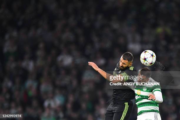 Real Madrid's French forward Karim Benzema heads the ball as he fights for it with Celtic's Croatian defender Josip Juranovic during the UEFA...